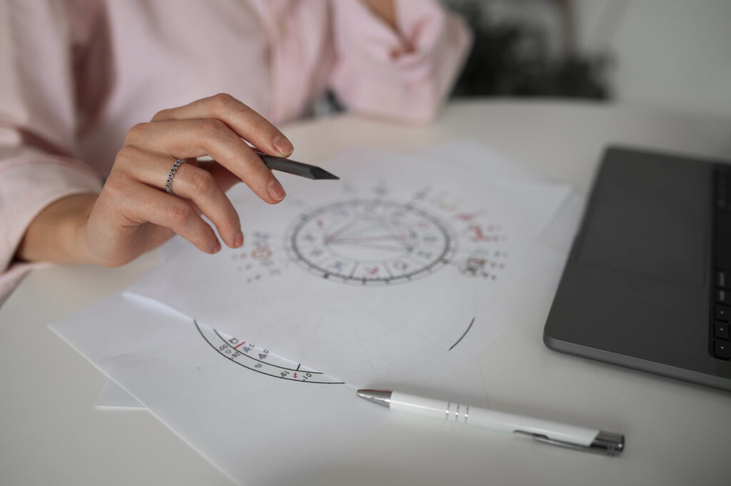side view woman reading tarot with laptop